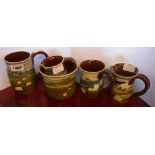 Five pieces of Abbot pottery comprising jugs, mugs and a vase, each decorated with sgraffito and