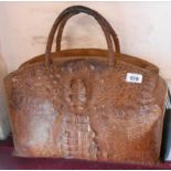 A large old crocodile skin handbag