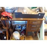 An old 94cm oak kneehole desk with single drop leaf and flight of three short drawers, set on square