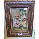 An ornate inlaid framed mid 20th Century Mughal painting, depicting three seated figures in an