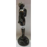 An Art Deco style cast metal figure with bronzed finish of a nude female set on marble plinth
