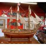 A 20th Century kit built wooden model of the HMS Bounty with full sail and rigging on wooden stand
