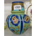 An Art Nouveau Burmantofts Faience vase decorated with moulded stylised flowers within continuous