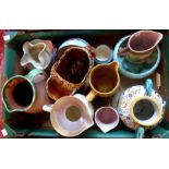 A box containing assorted ceramic items including majollica jugs, Torquay pottery, etc.