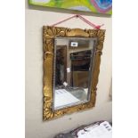 A reproduction carved giltwood style wall mirror with oblong plate