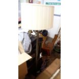 A heavy brass twin light standard lamp with reeded pillar, circular base and shades