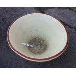 A large antique terracotta and slip dairy cream pan - hairline crack