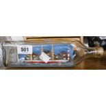 A vintage ship in a bottle depicting 'The Maud' with diorama