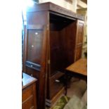 A 1.5m early 20th Century polished oak triple wardrobe with hanging space and four drawers