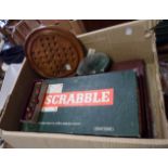 A box containing a quantity of assorted games including solitaire board with marbles, Scrabble,