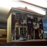 A mid 1960's Tri-ang doll's house with battery lights and contemporary furniture - paint peeling
