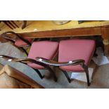 A set of six Victorian rosewood framed balloon back dining chairs with red machine tapestry