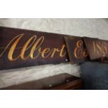 A carved, gilded and painted wood shop sign for Albert Edward Crocker, Estd. 1864 - 5.4m X 43cm