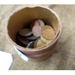 An old cigar tube containing a quantity of old coins mainly pennies and world coinage