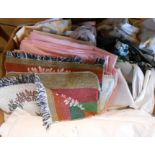 A box containing a quantity of textiles including tablecloths, etc.