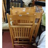 A set of four modern mixed wood folding chairs with slatted seats