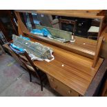 A 1.7m retro teak effect kneehole dressing table with long oblong mirror over flanking drawers,