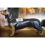 A modern cast metal dachshund form door stop