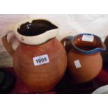 Two slip decorated terracotta milk jugs - various condition