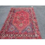A modern handmade rug with central geometric pattern and bird motifs within angular border - 2.1m