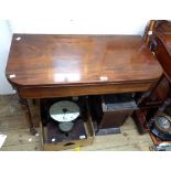 A 90cm 19th Century fold-over tea table, set on turned legs with brass caps and casters