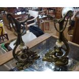 A pair of late 19th Century decorative cast brass decorative fireside stands with central onyx boss