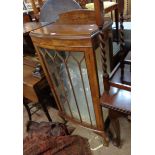 A 60cm 1930's figured walnut veneered bow front display cabinet with material lined interior and