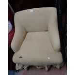 A vintage low box framed boudoir armchair with fitted cover, set on turned front legs