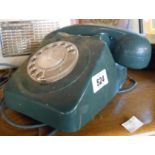 A vintage dial telephone in dark green colourway