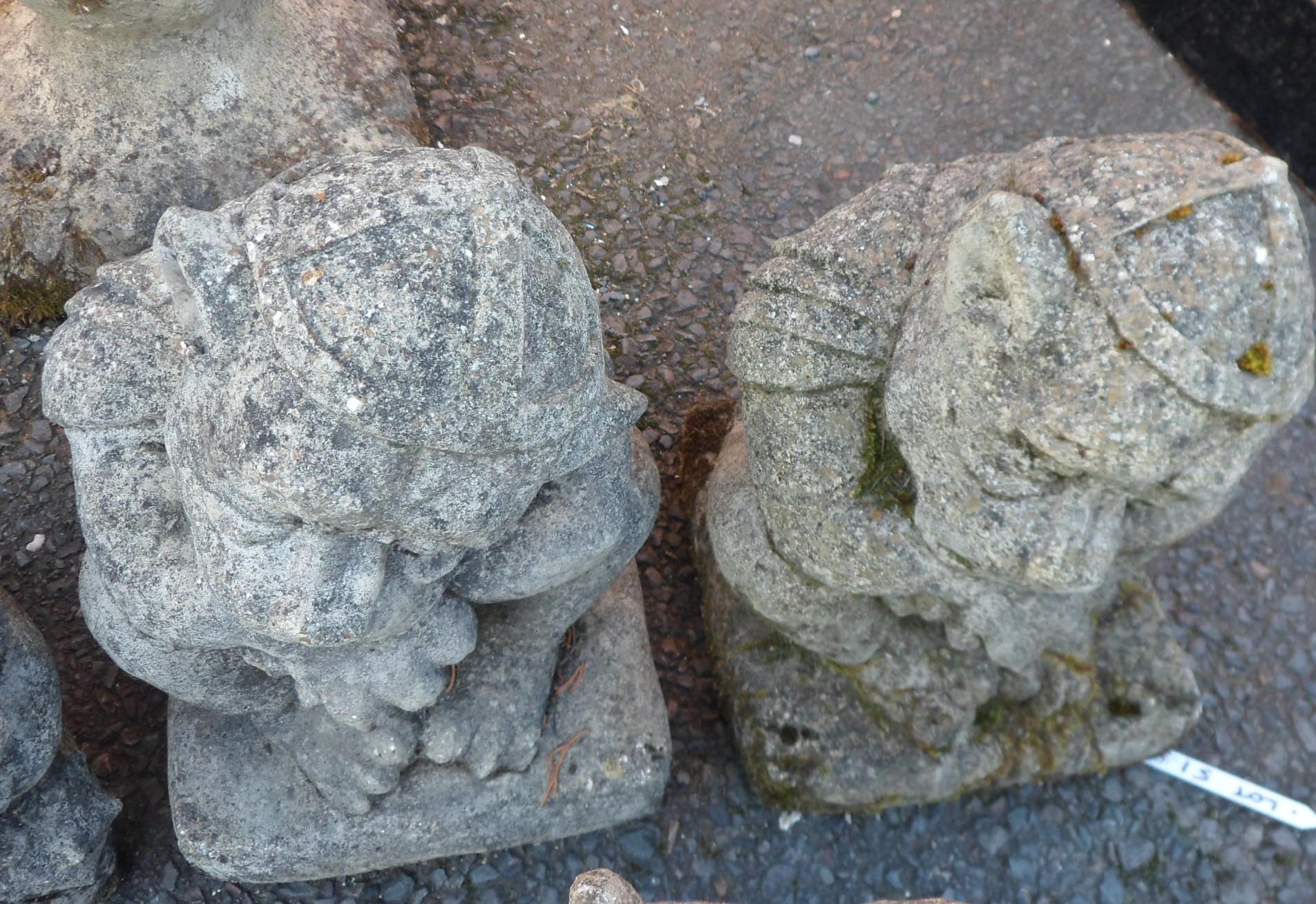 A pair of concrete gate keepers