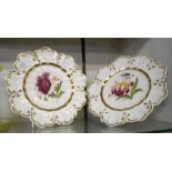 A pair of early 19th Century bone china cabinet plates decorated with hand painted botanical