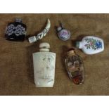 A small selection of Chinese and other snuff bottles including reverse painted glass, carved bone