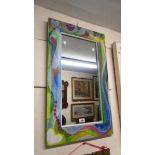 A decorative painted wood framed oblong wall mirror with heart decoration