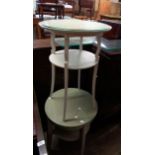 A painted wood two tier occasional table with glass top and slender cabriole supports - sold with