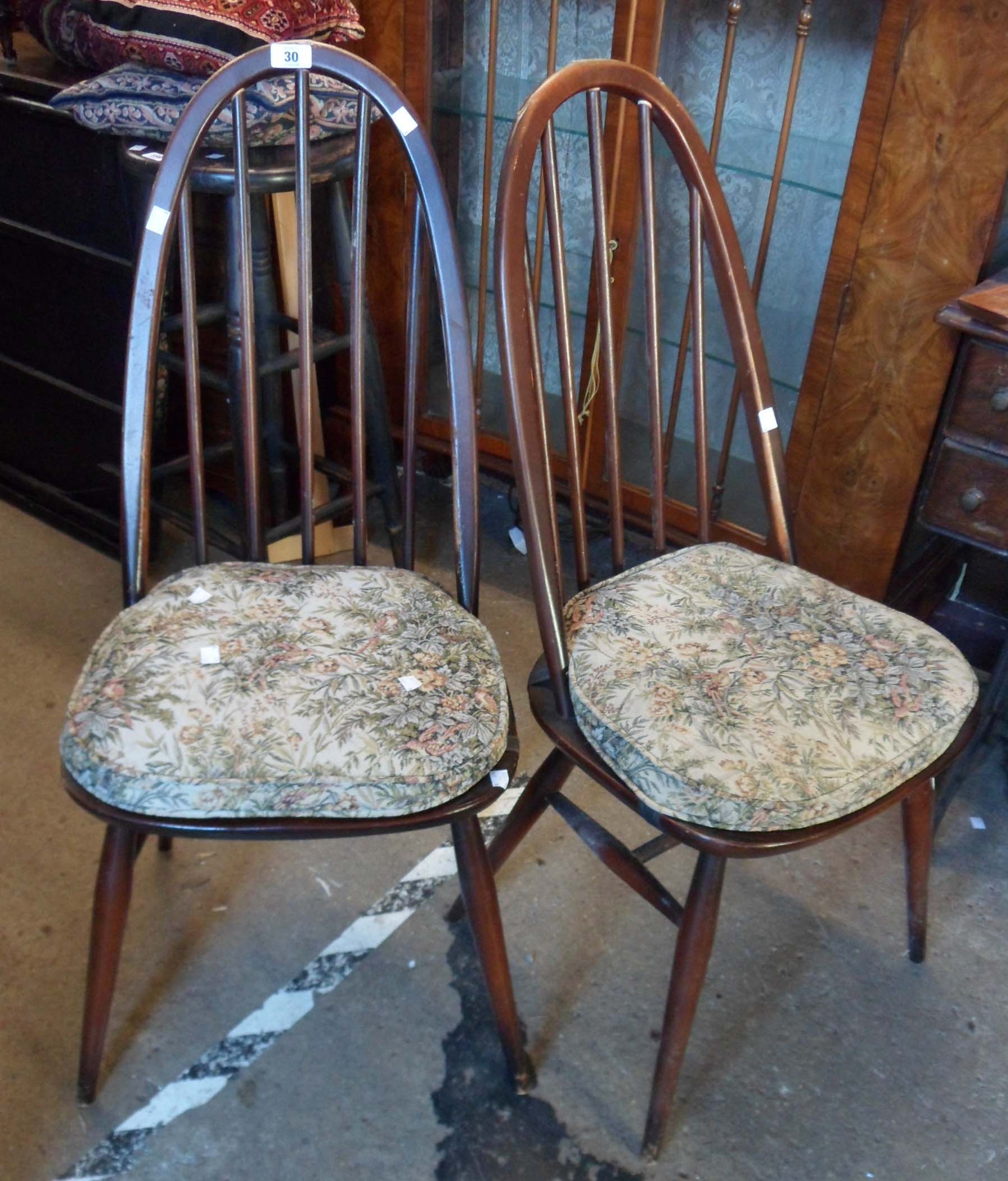 A pair of Ercol style elm stick back chairs in the dark finish