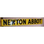 A vintage black on yellow enamel place sign for Newton Abbot