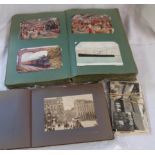 A green postcard album containing a collection of early 20th Century and later postcards including