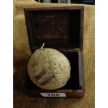 An old stitched leather baseball with ink stamped indistinct maker's mark and name and No. 1