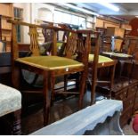 A pair of Edwardian stained beech and strung corner elbow chairs with upholstered seat panels, set