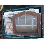 A crate containing a quantity of old stained and other glass window panes