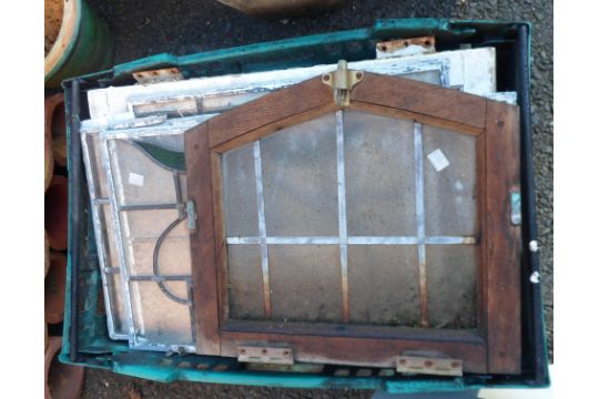 A crate containing a quantity of old stained and other glass window panes