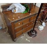 A 1.07m early 20th Century polished oak chest of drawers with low raised back, two short and two