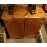 An 80cm modern pine two door cabinet