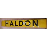 A vintage black on yellow enamel place sign for Haldon