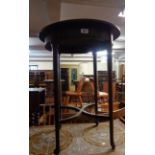 A 56cm diameter antique mahogany occasional table, set on tapered supports and uniting stretcher