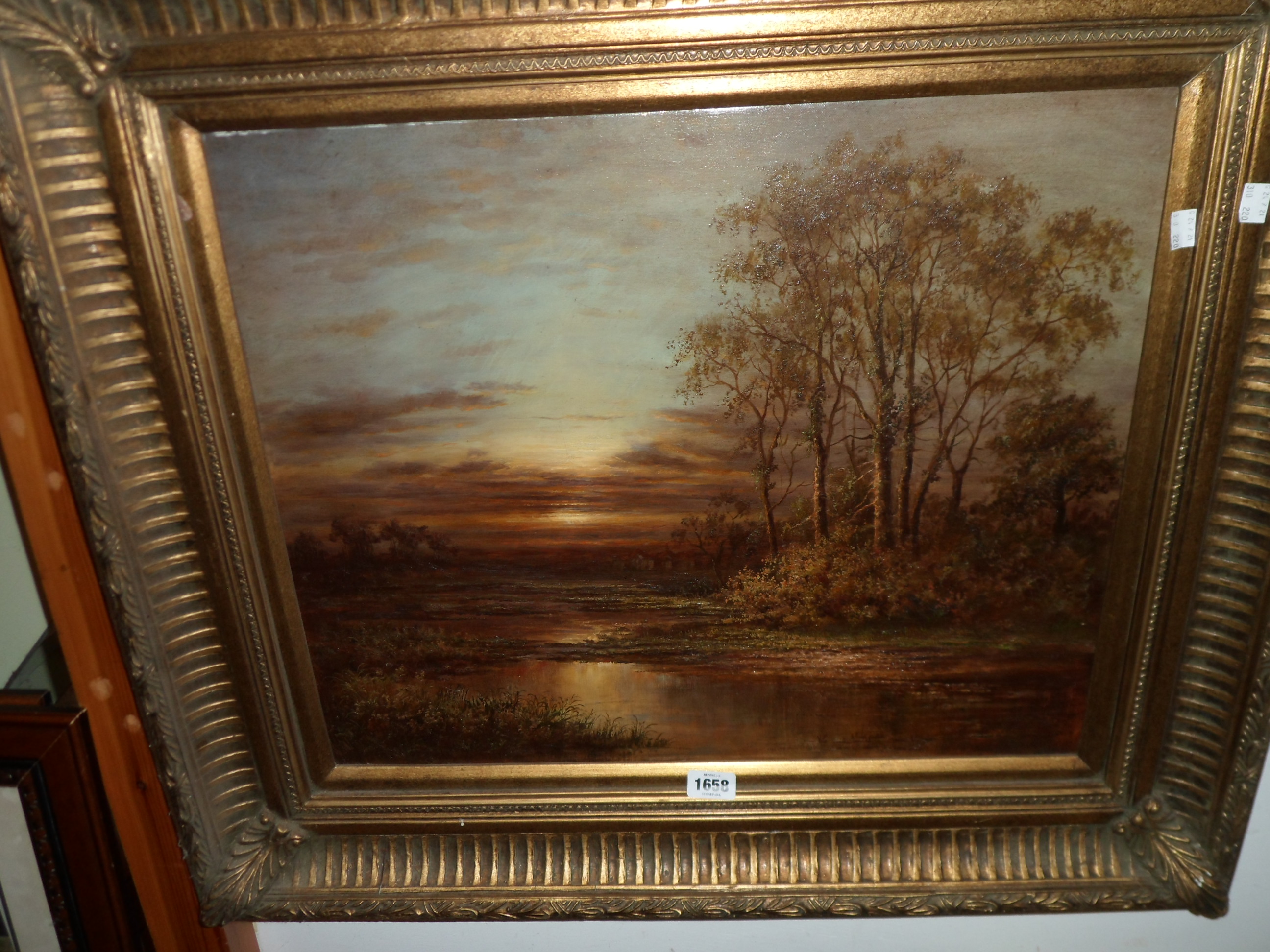 An ornate gilt framed oil on canvas, depicting a moonlit river landscape - unsigned - 49cm X 60cm