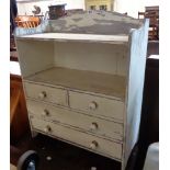 A 64cm shabby chic painted wood book unit with two open shelves over two short and two long drawers,