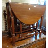 A 73cm 20th Century stained walnut gateleg table, set on turned supports