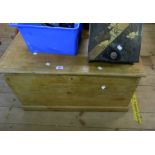 A 90cm antique polished pine lift-top box with internal candle box and flanking iron drop handles