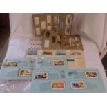 A quantity of cigarette cards, tea cards and stamps